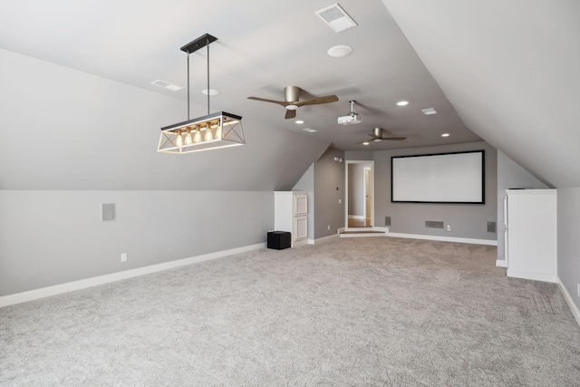 cinema with lofted ceiling, carpet, visible vents, and baseboards