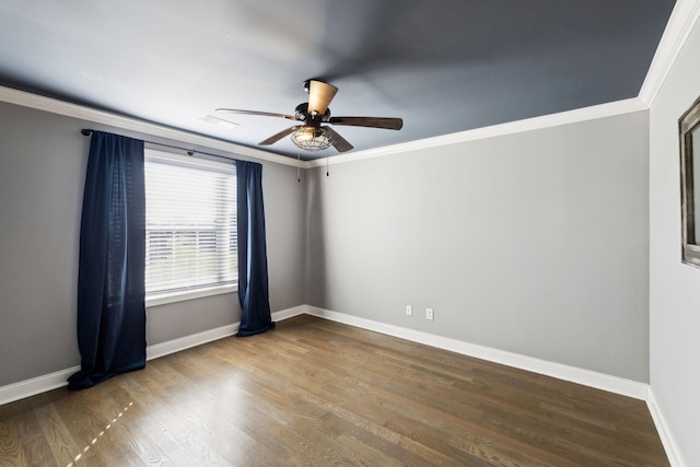 unfurnished room with baseboards, wood finished floors, a ceiling fan, and crown molding