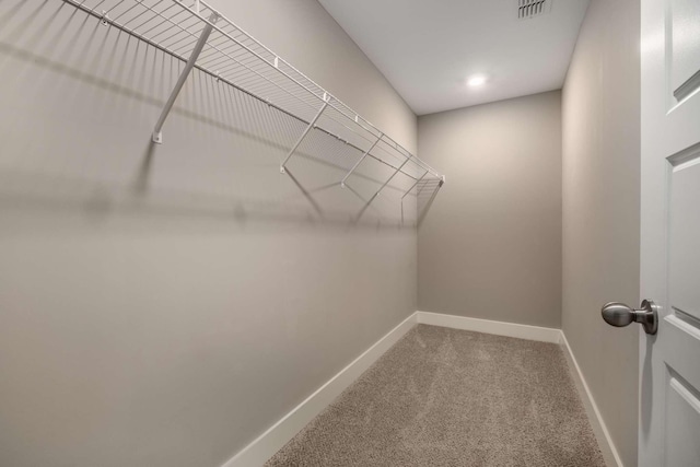 walk in closet with carpet floors and visible vents