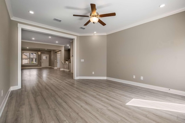 spare room featuring visible vents, baseboards, and wood finished floors