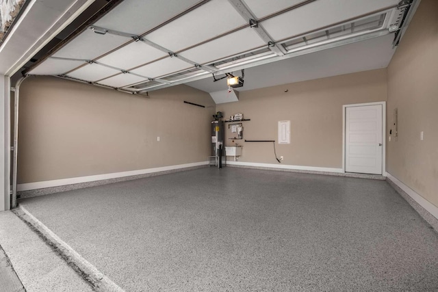 garage featuring baseboards, water heater, and a garage door opener