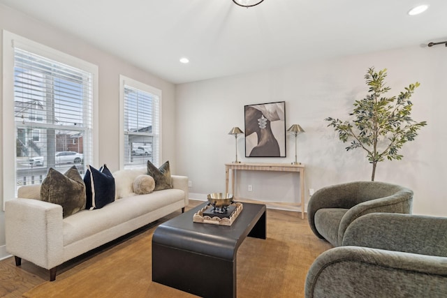 living area featuring recessed lighting, baseboards, and wood finished floors