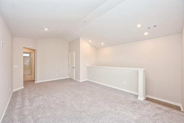 unfurnished room featuring baseboards, visible vents, lofted ceiling, carpet floors, and recessed lighting