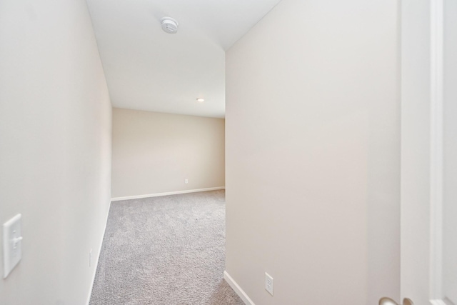 corridor featuring carpet floors and baseboards