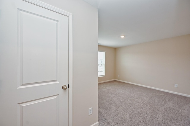 empty room with carpet and baseboards