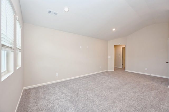 empty room featuring visible vents, baseboards, carpet, vaulted ceiling, and recessed lighting