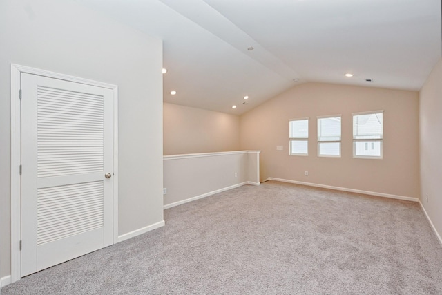 spare room with lofted ceiling, baseboards, carpet floors, and recessed lighting