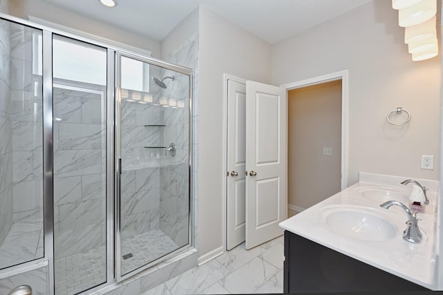 full bathroom with marble finish floor, double vanity, a sink, and a shower stall