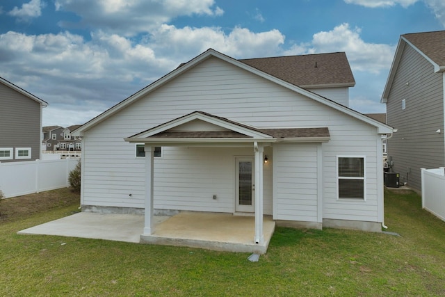 rear view of property featuring a yard, a patio, a fenced backyard, and central air condition unit