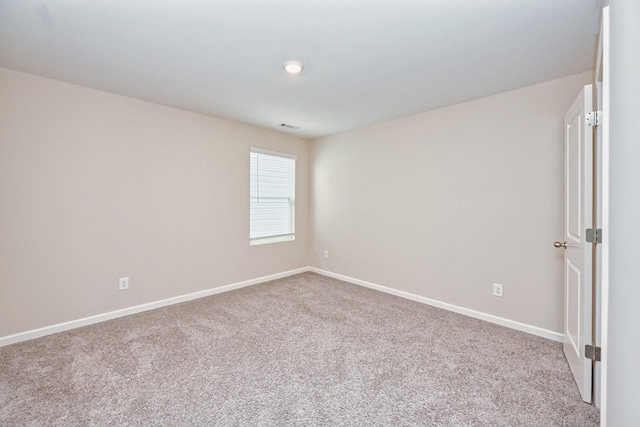 unfurnished room featuring baseboards and carpet flooring