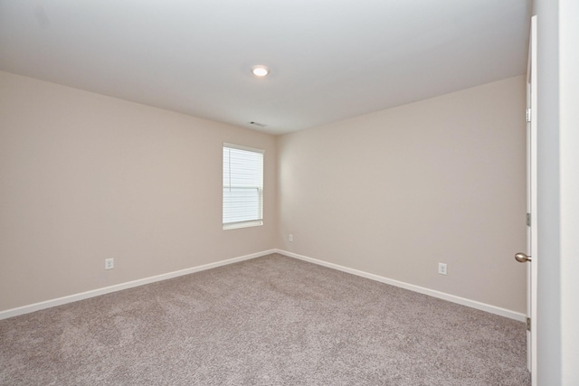 carpeted empty room with baseboards