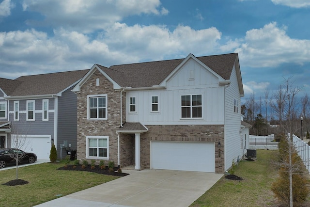 view of front of house with an attached garage, a front lawn, board and batten siding, and brick siding