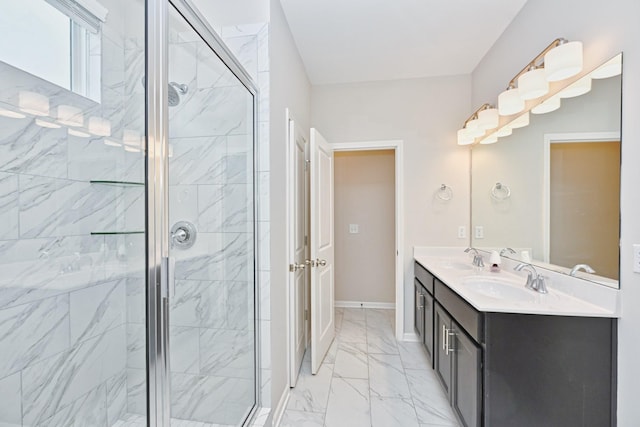 full bath featuring a stall shower, marble finish floor, a sink, and double vanity