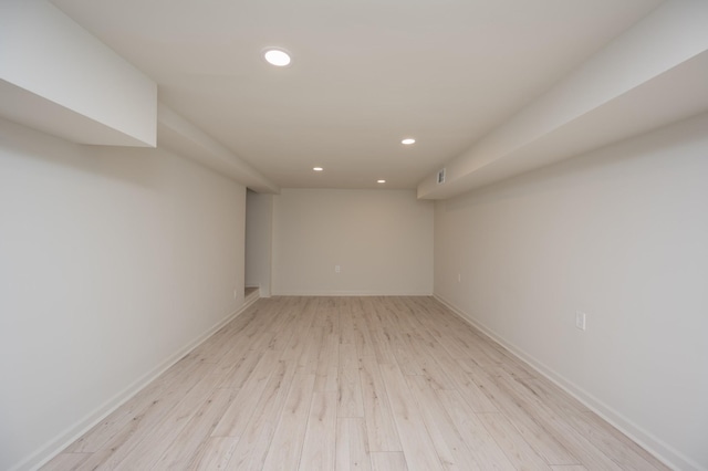 unfurnished room with baseboards, light wood-type flooring, and recessed lighting