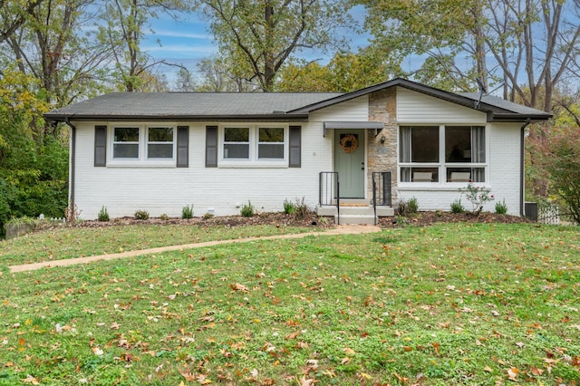 ranch-style house with brick siding and a front lawn