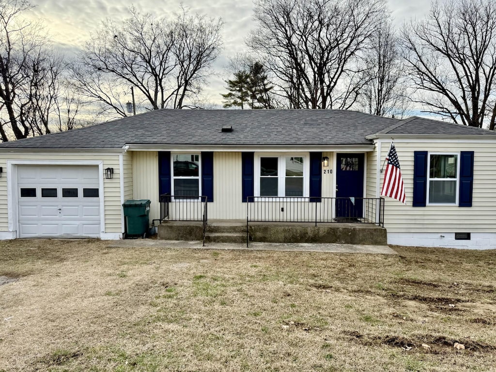 single story home featuring a porch, a front yard, crawl space, and an attached garage