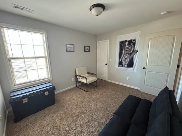 sitting room with carpet, visible vents, and baseboards