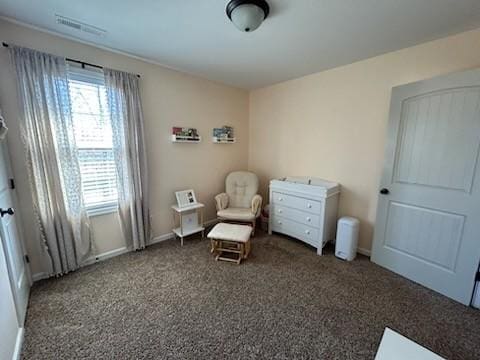 sitting room featuring carpet floors, visible vents, and baseboards