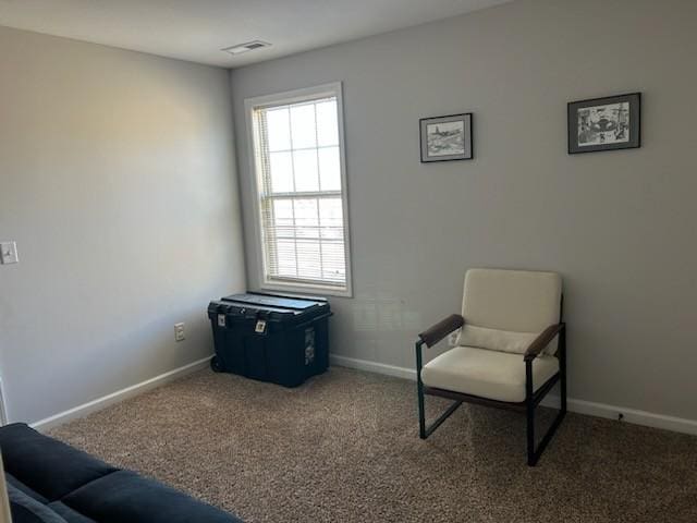 sitting room featuring carpet floors, baseboards, and visible vents