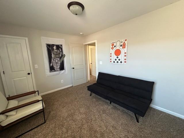 sitting room with carpet flooring and baseboards