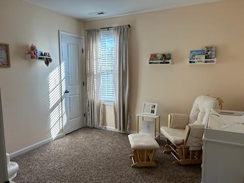 sitting room with carpet and baseboards