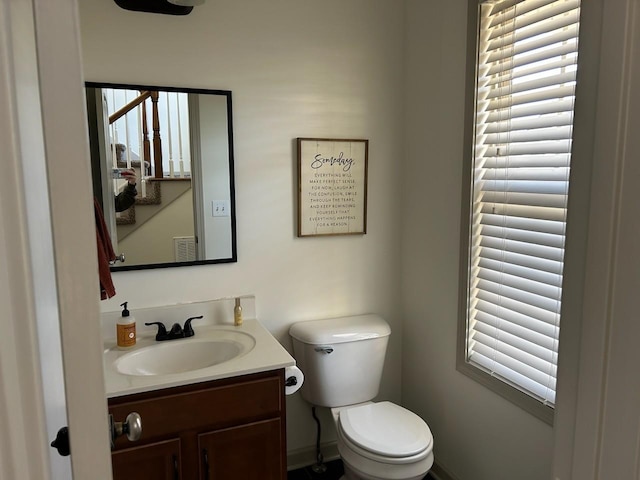 bathroom featuring visible vents, vanity, and toilet