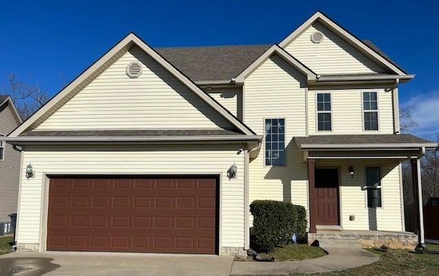 traditional-style house featuring concrete driveway, a porch, and an attached garage