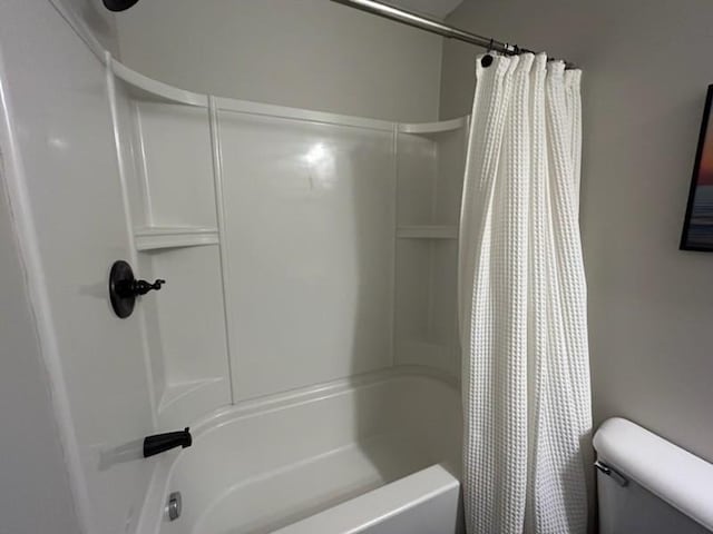 bathroom with toilet and shower / tub combo