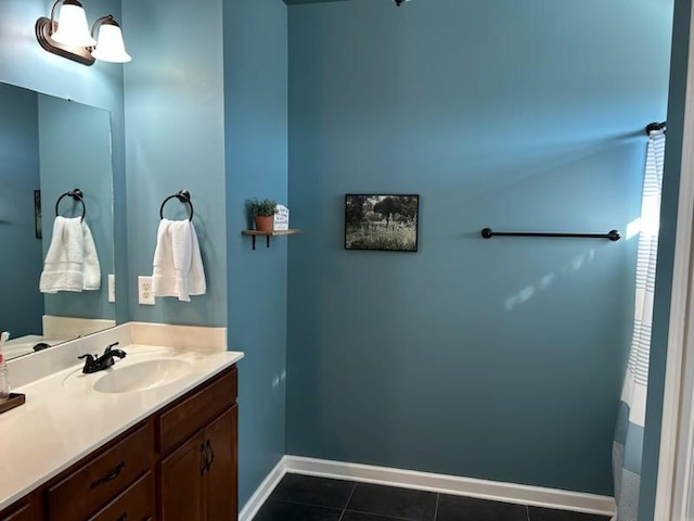 bathroom with tile patterned flooring, baseboards, and vanity