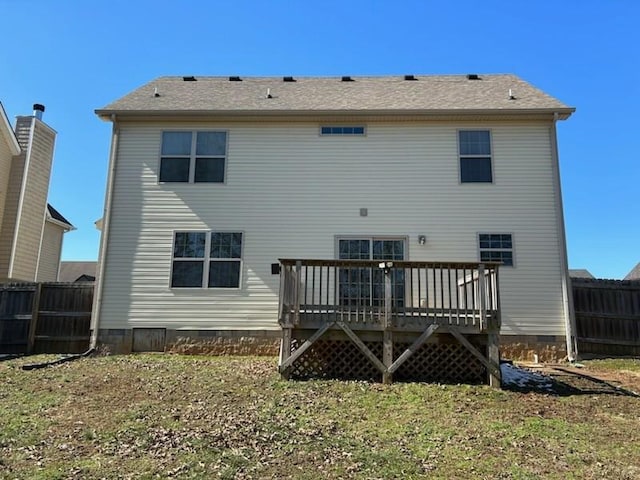 rear view of house featuring crawl space, fence, and a deck