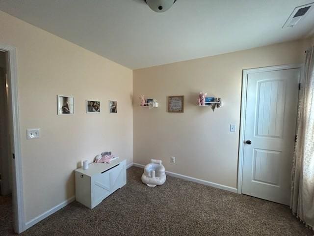 interior space featuring carpet floors, visible vents, and baseboards