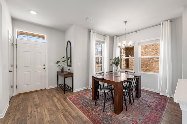 dining space with a chandelier, wood finished floors, visible vents, and a healthy amount of sunlight