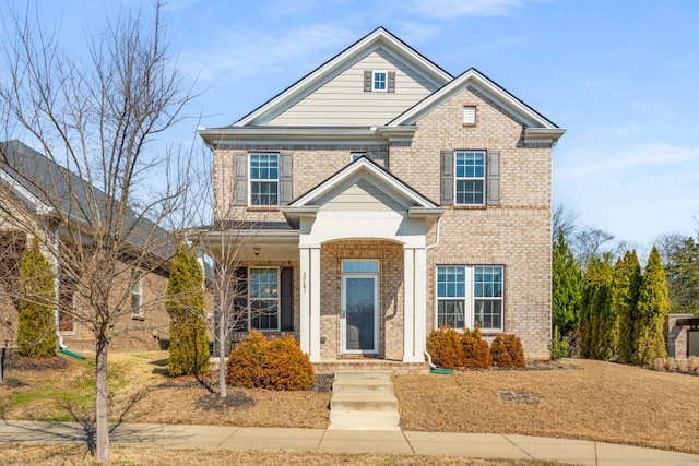 traditional-style home with brick siding