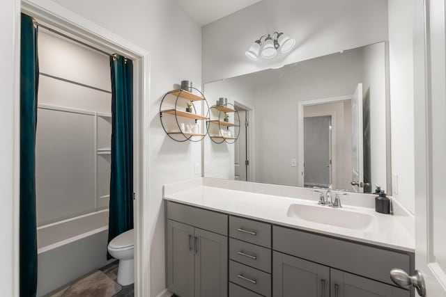 bathroom featuring shower / bath combo with shower curtain, vanity, and toilet