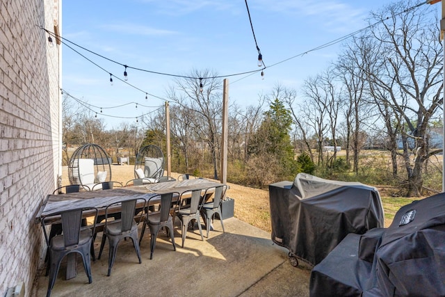 view of patio with outdoor dining area and a grill