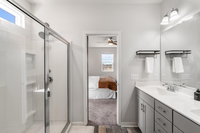 full bathroom featuring double vanity, a stall shower, ensuite bath, and a sink