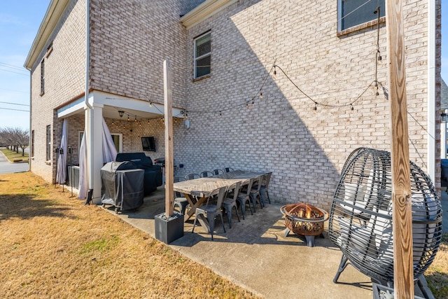 view of patio with an outdoor fire pit and grilling area