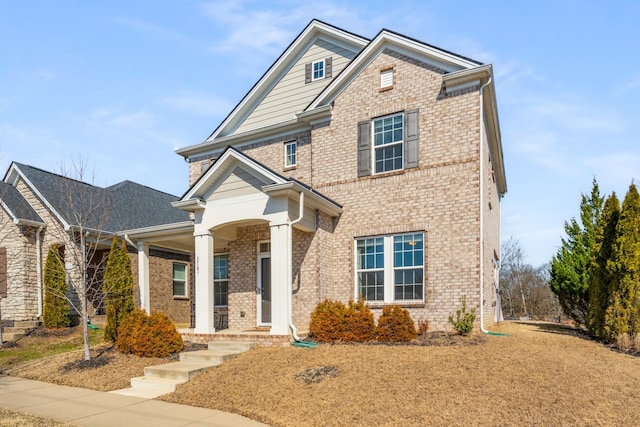 view of front facade with a porch and brick siding