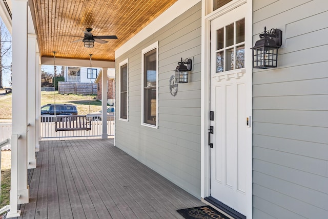 wooden deck with covered porch and ceiling fan