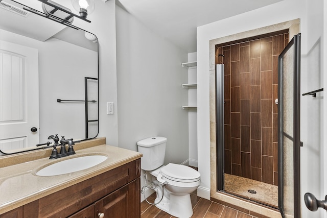 full bath featuring wood finish floors, visible vents, a shower stall, and toilet