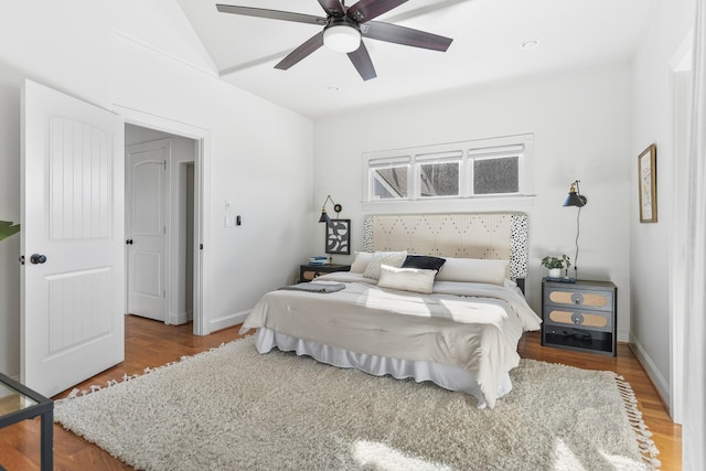 bedroom featuring ceiling fan, baseboards, and wood finished floors