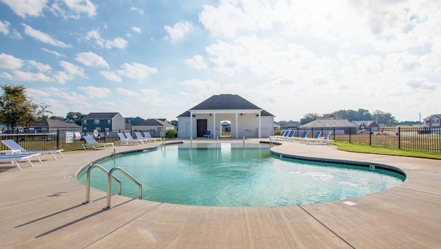 pool featuring a patio area and fence