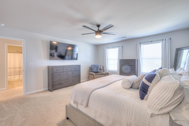 bedroom with baseboards, a ceiling fan, visible vents, and light colored carpet