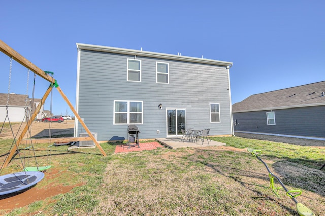 back of house with a yard and a patio