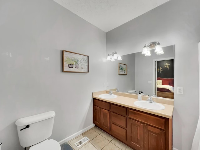 bathroom with toilet, ensuite bath, a sink, and visible vents