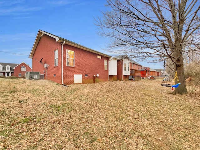 view of property exterior featuring central AC, brick siding, and crawl space