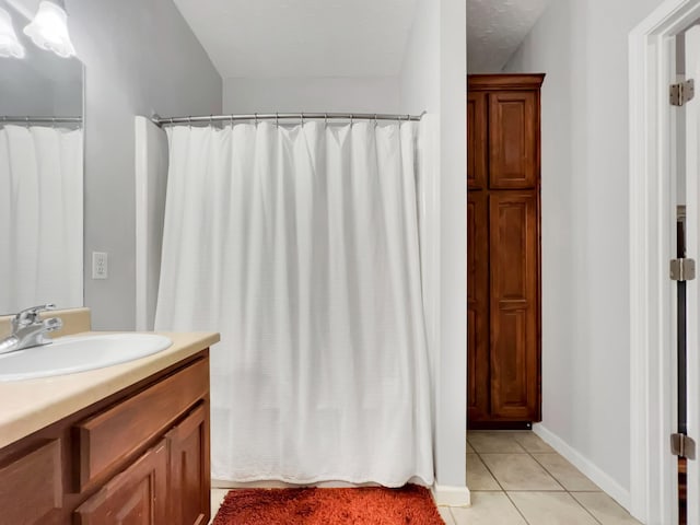 full bath featuring tile patterned flooring, vanity, and baseboards