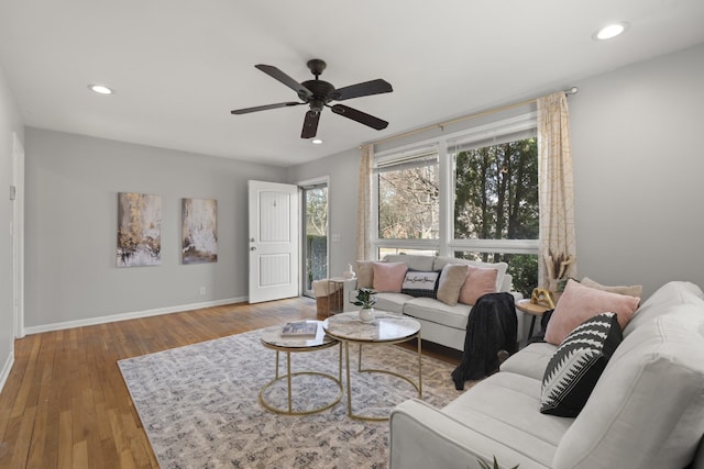 living area with ceiling fan, baseboards, wood finished floors, and recessed lighting