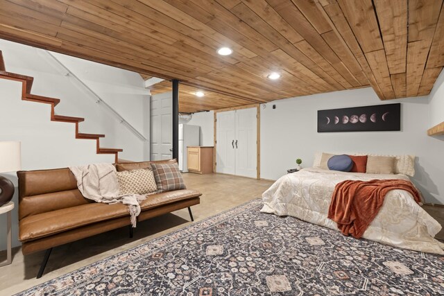 bedroom with finished concrete flooring, wood ceiling, and recessed lighting