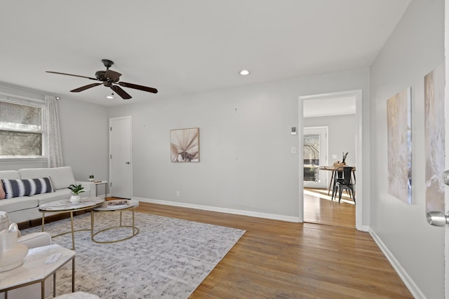 living area featuring ceiling fan, recessed lighting, wood finished floors, and baseboards